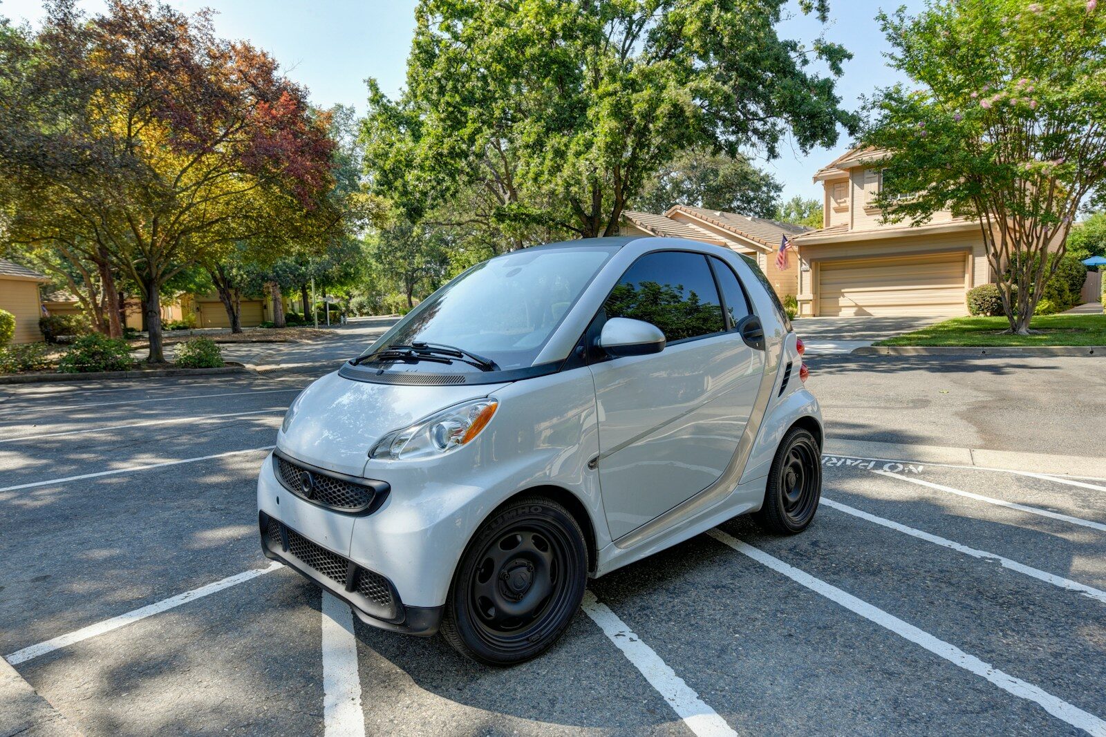 a smart car parked in a parking lot